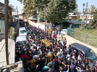 People carry the dead body of a doctor who is killed in an alleged militant attack in the Nadigam area of Budgam district, Indian-administer...