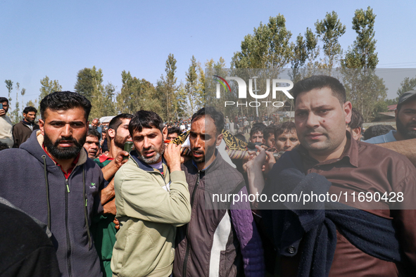 People carry the dead body of a doctor who is killed in an alleged militant attack in the Nadigam area of Budgam district, Indian-administer...