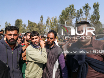 People carry the dead body of a doctor who is killed in an alleged militant attack in the Nadigam area of Budgam district, Indian-administer...