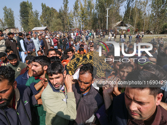 People carry the dead body of a doctor who is killed in an alleged militant attack in the Nadigam area of Budgam district, Indian-administer...