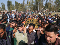 People carry the dead body of a doctor who is killed in an alleged militant attack in the Nadigam area of Budgam district, Indian-administer...