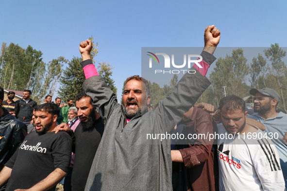 People shout slogans during the funeral of a doctor who is killed in an alleged militant attack in the Nadigam area of Budgam district, Indi...