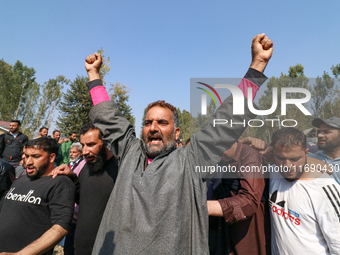 People shout slogans during the funeral of a doctor who is killed in an alleged militant attack in the Nadigam area of Budgam district, Indi...