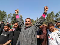 People shout slogans during the funeral of a doctor who is killed in an alleged militant attack in the Nadigam area of Budgam district, Indi...