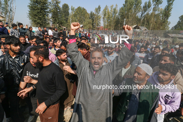 People shout slogans during the funeral of a doctor who is killed in an alleged militant attack in the Nadigam area of Budgam district, Indi...