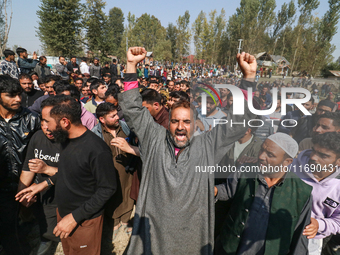 People shout slogans during the funeral of a doctor who is killed in an alleged militant attack in the Nadigam area of Budgam district, Indi...