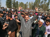 People shout slogans during the funeral of a doctor who is killed in an alleged militant attack in the Nadigam area of Budgam district, Indi...