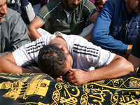 People wail during the funeral of a doctor who is killed in an alleged militant attack in the Nadigam area of Budgam district, Indian-admini...