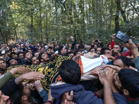 People carry the dead body of a doctor who is killed in an alleged militant attack in the Nadigam area of Budgam district, Indian-administer...