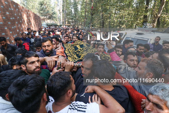 People carry the dead body of a doctor who is killed in an alleged militant attack in the Nadigam area of Budgam district, Indian-administer...