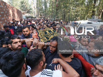 People carry the dead body of a doctor who is killed in an alleged militant attack in the Nadigam area of Budgam district, Indian-administer...