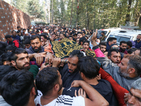 People carry the dead body of a doctor who is killed in an alleged militant attack in the Nadigam area of Budgam district, Indian-administer...