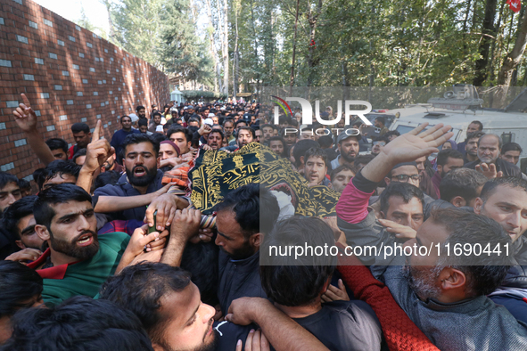 People carry the dead body of a doctor who is killed in an alleged militant attack in the Nadigam area of Budgam district, Indian-administer...