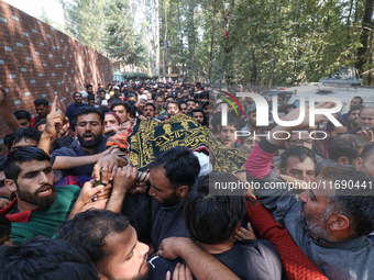 People carry the dead body of a doctor who is killed in an alleged militant attack in the Nadigam area of Budgam district, Indian-administer...