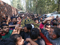 People carry the dead body of a doctor who is killed in an alleged militant attack in the Nadigam area of Budgam district, Indian-administer...