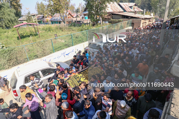 People carry the dead body of a doctor who is killed in an alleged militant attack in the Nadigam area of Budgam district, Indian-administer...