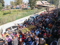 People carry the dead body of a doctor who is killed in an alleged militant attack in the Nadigam area of Budgam district, Indian-administer...