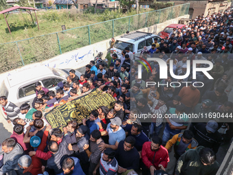 People carry the dead body of a doctor who is killed in an alleged militant attack in the Nadigam area of Budgam district, Indian-administer...