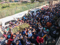 People carry the dead body of a doctor who is killed in an alleged militant attack in the Nadigam area of Budgam district, Indian-administer...