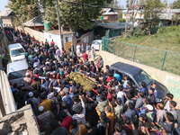 People carry the dead body of a doctor who is killed in an alleged militant attack in the Nadigam area of Budgam district, Indian-administer...