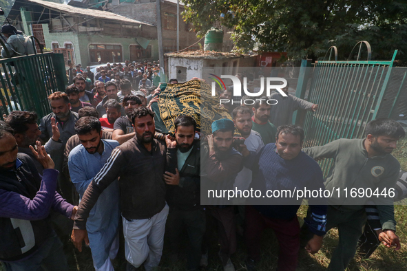 People carry the dead body of a doctor who is killed in an alleged militant attack in the Nadigam area of Budgam district, Indian-administer...