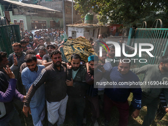 People carry the dead body of a doctor who is killed in an alleged militant attack in the Nadigam area of Budgam district, Indian-administer...