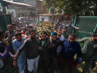 People carry the dead body of a doctor who is killed in an alleged militant attack in the Nadigam area of Budgam district, Indian-administer...