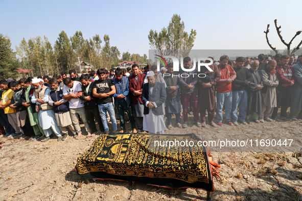 People attend the funeral of a doctor who is killed in an alleged militant attack in the Nadigam area of Budgam district, Indian-administere...