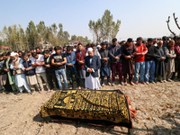 People attend the funeral of a doctor who is killed in an alleged militant attack in the Nadigam area of Budgam district, Indian-administere...