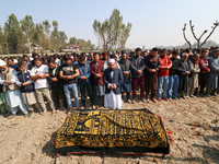 People attend the funeral of a doctor who is killed in an alleged militant attack in the Nadigam area of Budgam district, Indian-administere...