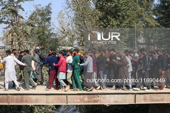 People carry the dead body of a doctor who is killed in an alleged militant attack in the Nadigam area of Budgam district, Indian-administer...