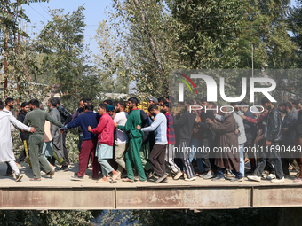 People carry the dead body of a doctor who is killed in an alleged militant attack in the Nadigam area of Budgam district, Indian-administer...