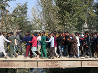 People carry the dead body of a doctor who is killed in an alleged militant attack in the Nadigam area of Budgam district, Indian-administer...