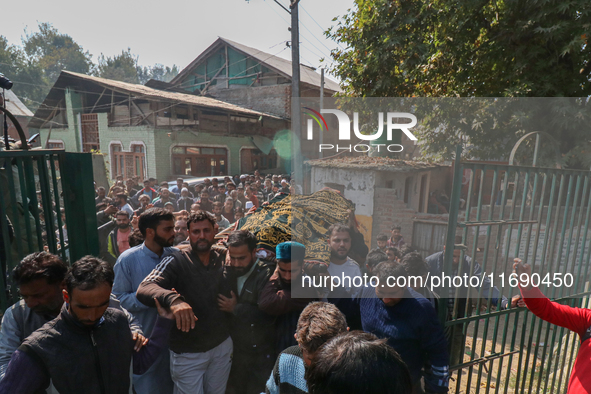 People carry the dead body of a doctor who is killed in an alleged militant attack in the Nadigam area of Budgam district, Indian-administer...