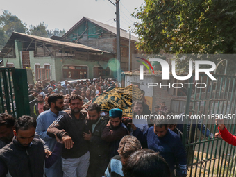 People carry the dead body of a doctor who is killed in an alleged militant attack in the Nadigam area of Budgam district, Indian-administer...