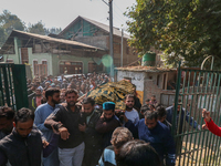 People carry the dead body of a doctor who is killed in an alleged militant attack in the Nadigam area of Budgam district, Indian-administer...