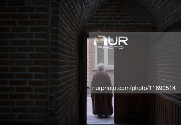 An Iranian cleric stands at the door of a mosque in the historical city of Tabriz, Iran, on October 17, 2024. 