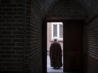 An Iranian cleric stands at the door of a mosque in the historical city of Tabriz, Iran, on October 17, 2024. (