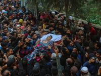 Relatives and mourners carry the body of Kashmiri doctor Shahnawaz Dar at Nadigam village southwest of Srinagar, Jammu and Kashmir, on Octob...