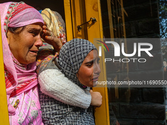 Relatives and mourners grieve during the funeral procession of Kashmiri doctor Shahnawaz Dar in Nadigam village, southwest of Srinagar, Jamm...