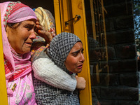 Relatives and mourners grieve during the funeral procession of Kashmiri doctor Shahnawaz Dar in Nadigam village, southwest of Srinagar, Jamm...