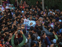 Relatives and mourners carry the body of Kashmiri doctor Shahnawaz Dar at Nadigam village southwest of Srinagar, Jammu and Kashmir, on Octob...