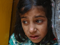 A girl weeps during the funeral procession of Kashmiri doctor Shahnawaz Dar in Nadigam village southwest of Srinagar, Jammu and Kashmir, on...