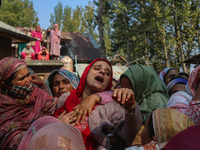 Relatives and mourners grieve during the funeral procession of Kashmiri doctor Shahnawaz Dar in Nadigam village, southwest of Srinagar, Jamm...