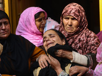 Relatives and mourners grieve during the funeral procession of Kashmiri doctor Shahnawaz Dar in Nadigam village, southwest of Srinagar, Jamm...