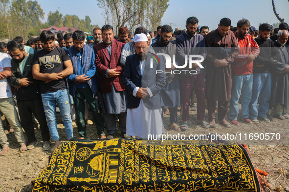 Relatives and mourners offer funeral prayers near the body of Kashmiri doctor Shahnawaz Dar in Nadigam village southwest of Srinagar, Jammu...