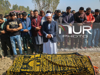 Relatives and mourners offer funeral prayers near the body of Kashmiri doctor Shahnawaz Dar in Nadigam village southwest of Srinagar, Jammu...