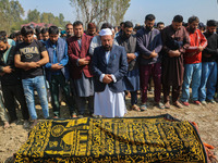 Relatives and mourners offer funeral prayers near the body of Kashmiri doctor Shahnawaz Dar in Nadigam village southwest of Srinagar, Jammu...