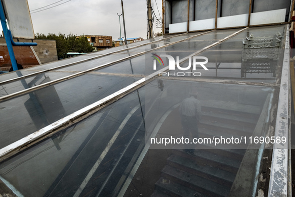 An elderly Iranian man climbs stairs while leaving an underground pedestrian way near a market (bazaar) in the historical city of Tabriz, lo...