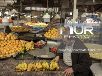 An Iranian salesman places bananas on a cart at a bazaar in the historical city of Tabriz, located 624 km northwest of Tehran in the Eastern...